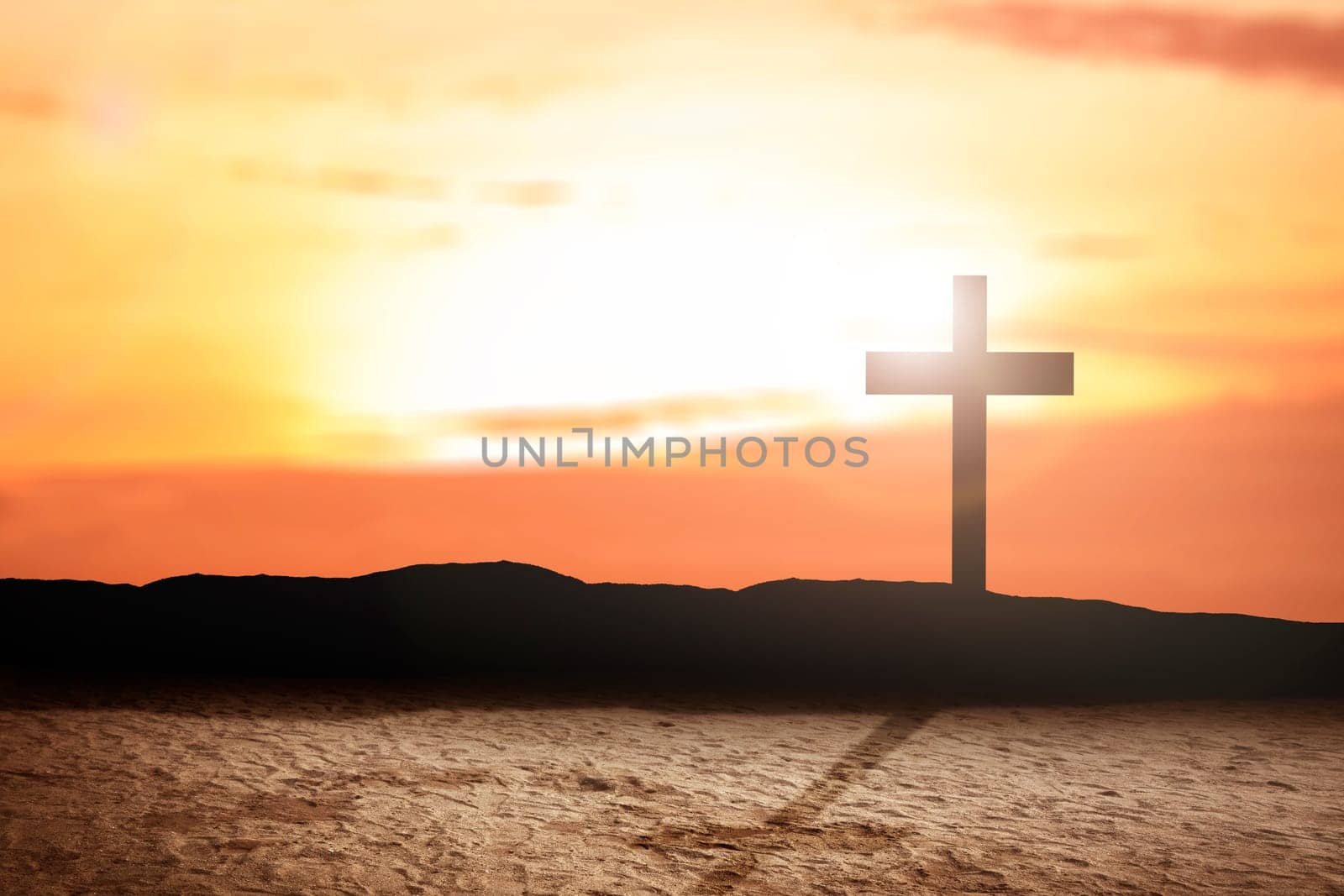 Christian Cross on the field with a sunset sky background