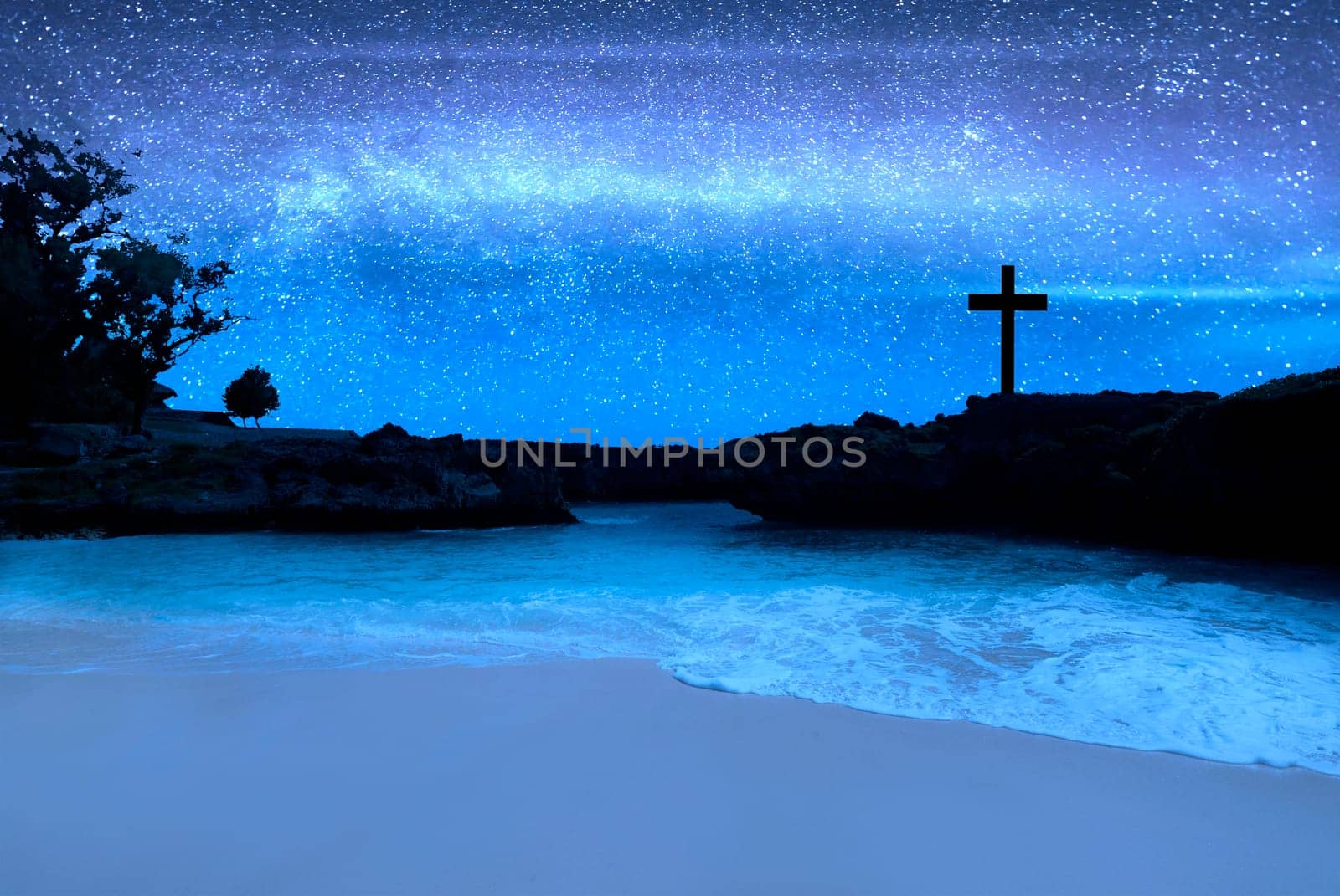 Christian Cross on the beach with a night scene background