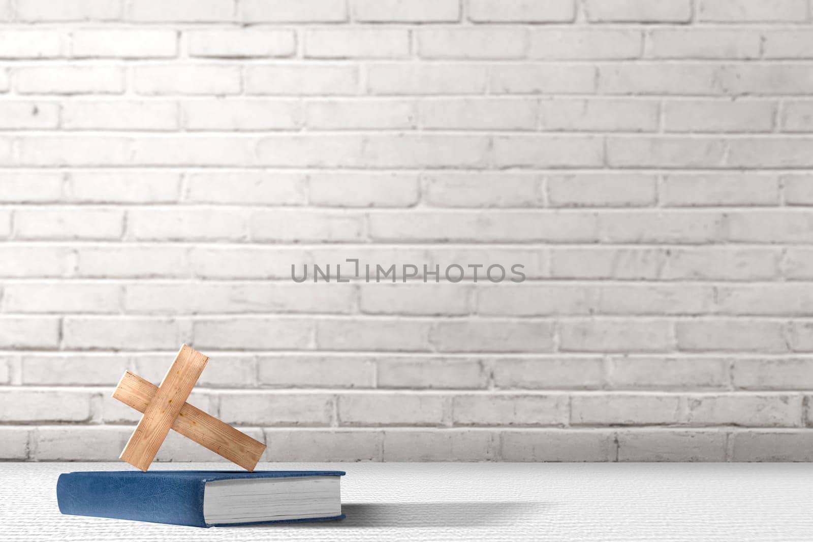 Christian Cross and bible on the table with brick wall background