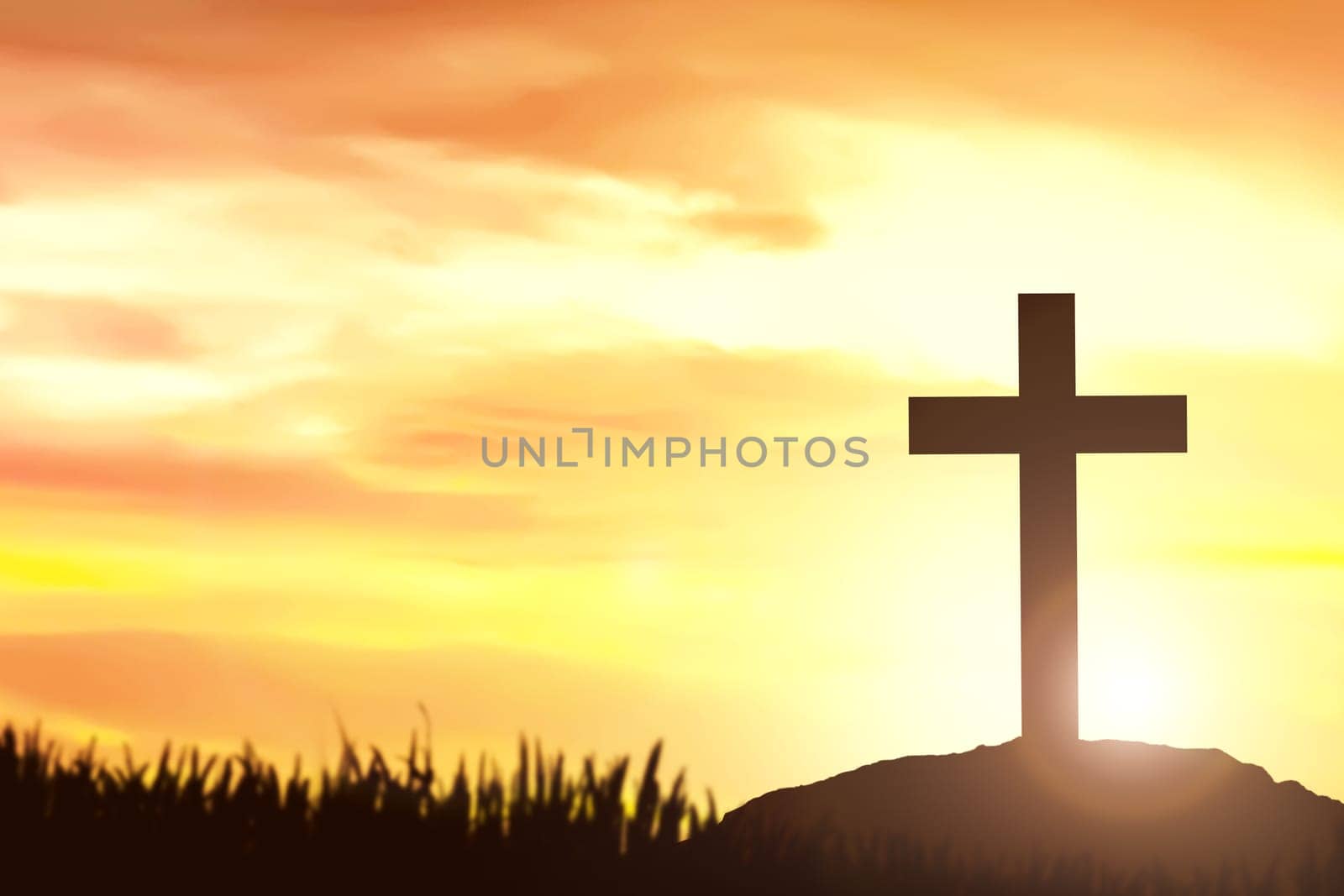 Christian Cross on the field with a sunset sky background