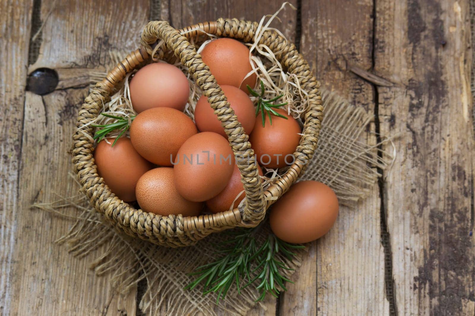 eggs in a basket on wooden background