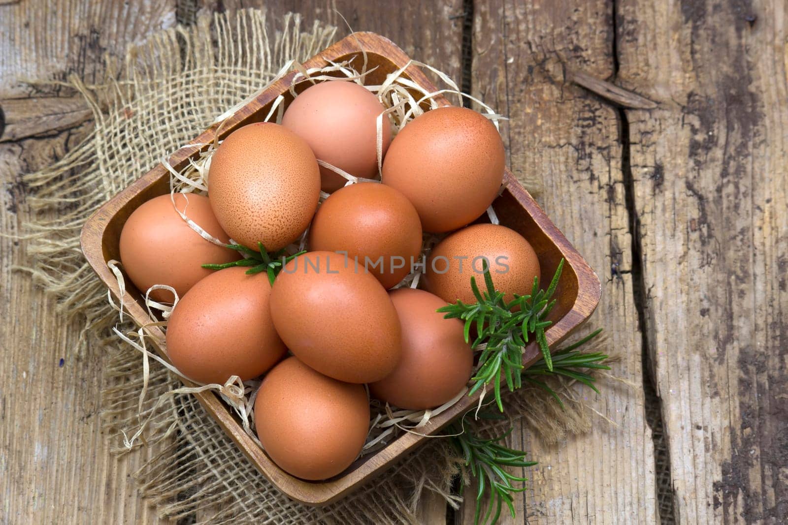 eggs in a bowl on wooden background