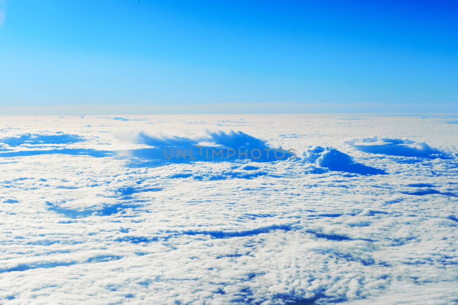 Blue sky and clouds. Plane view above the earth, can be used for background