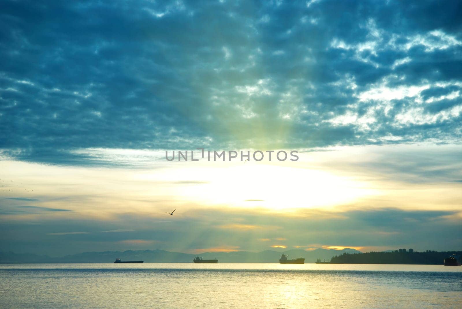 Sunset on the sea. Coastline and beautiful cloudscape.