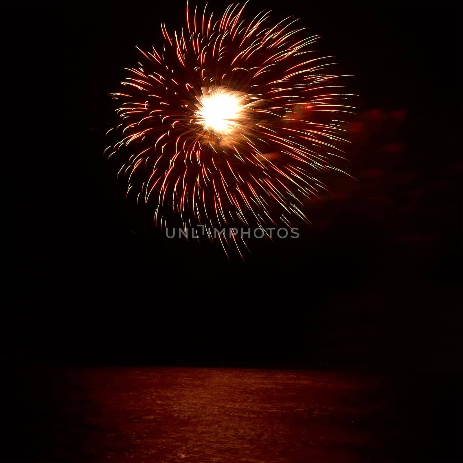 Red colorful holiday fireworks on the black sky background.