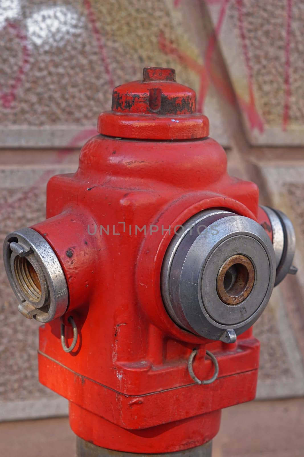 Red fire hydrant with water valve close up