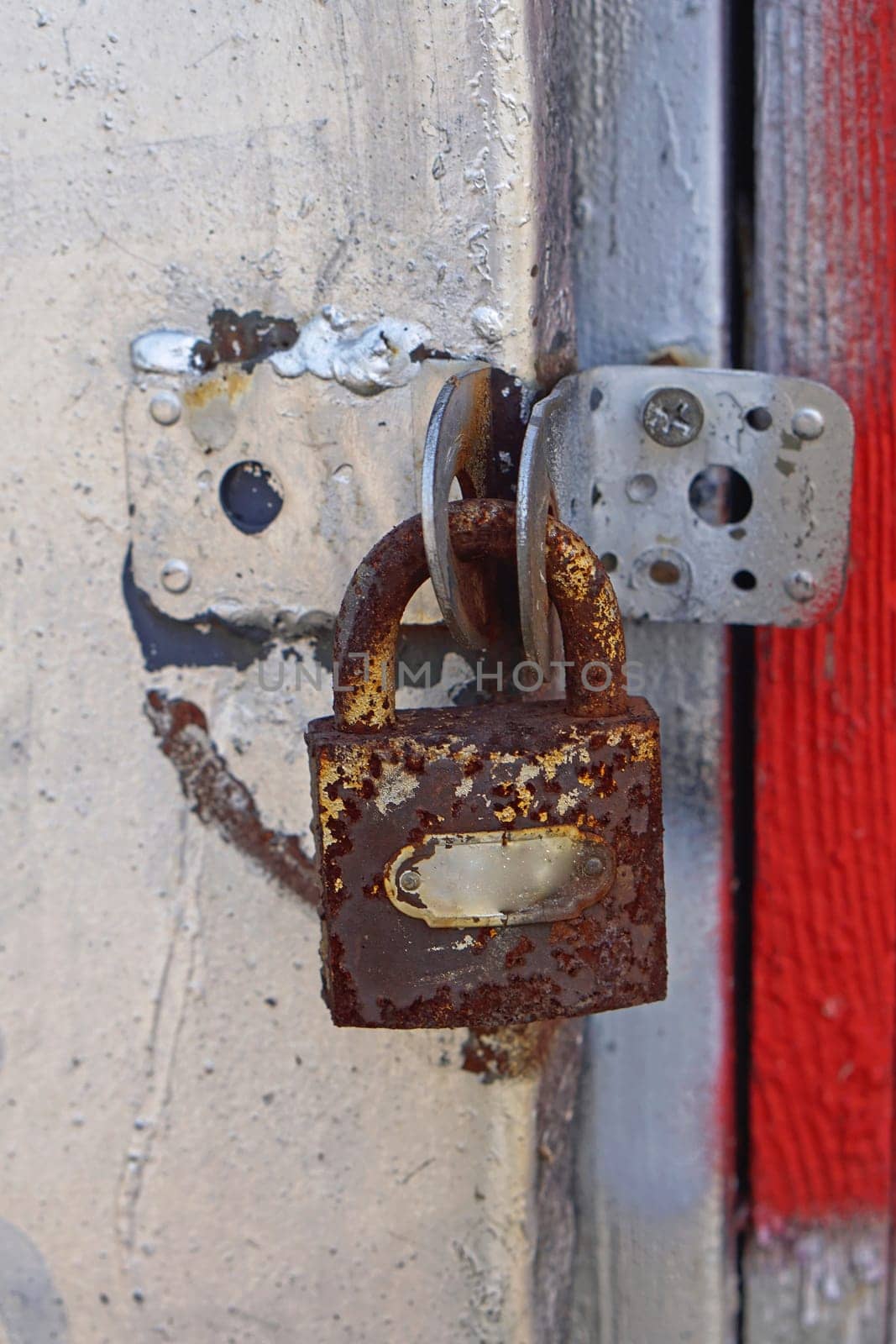 Old rusty padlock at abandoned storage unit
