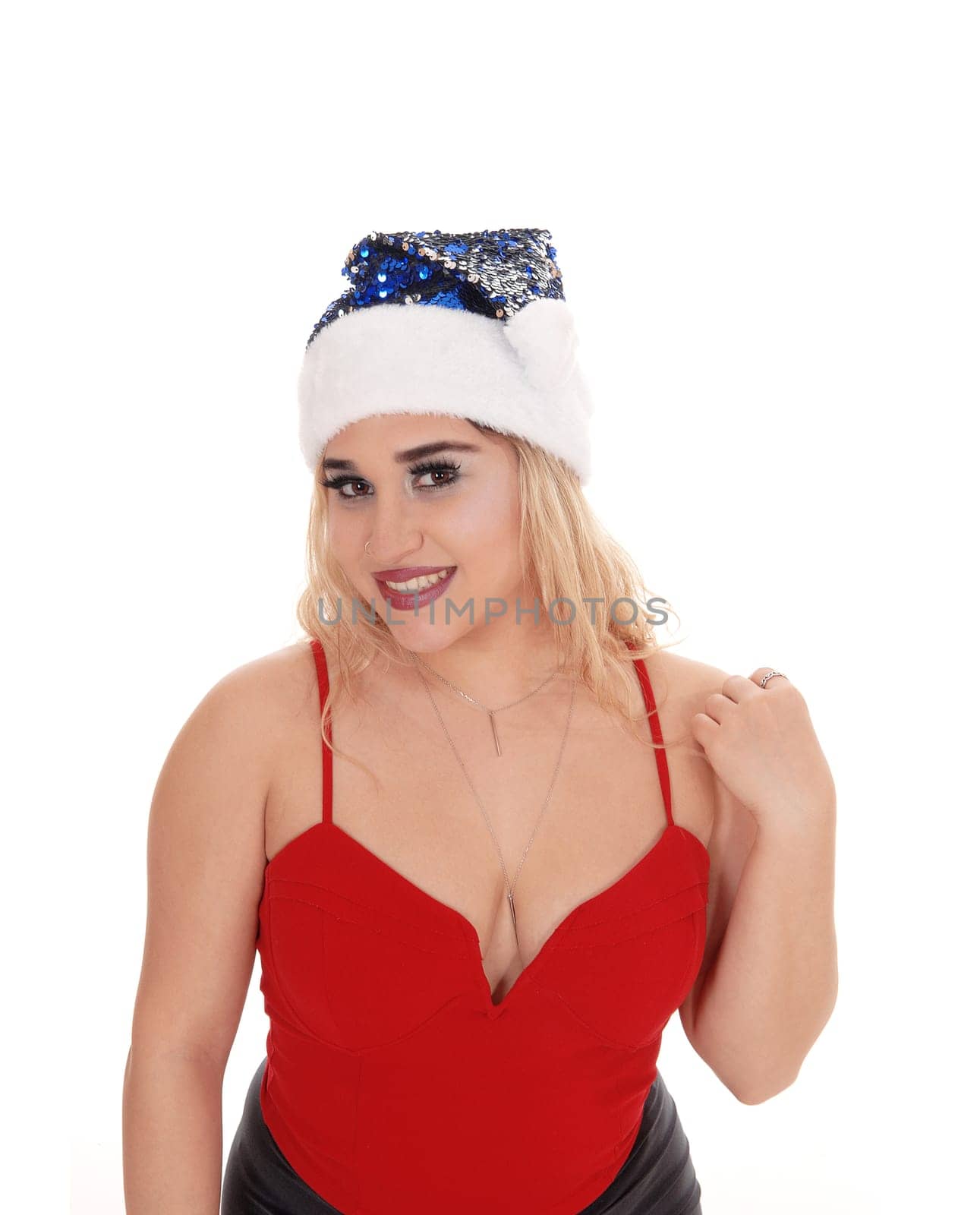 Beautiful blond woman in a close-up image in a red top and a blue.santé hat, smiling, isolated for white background.