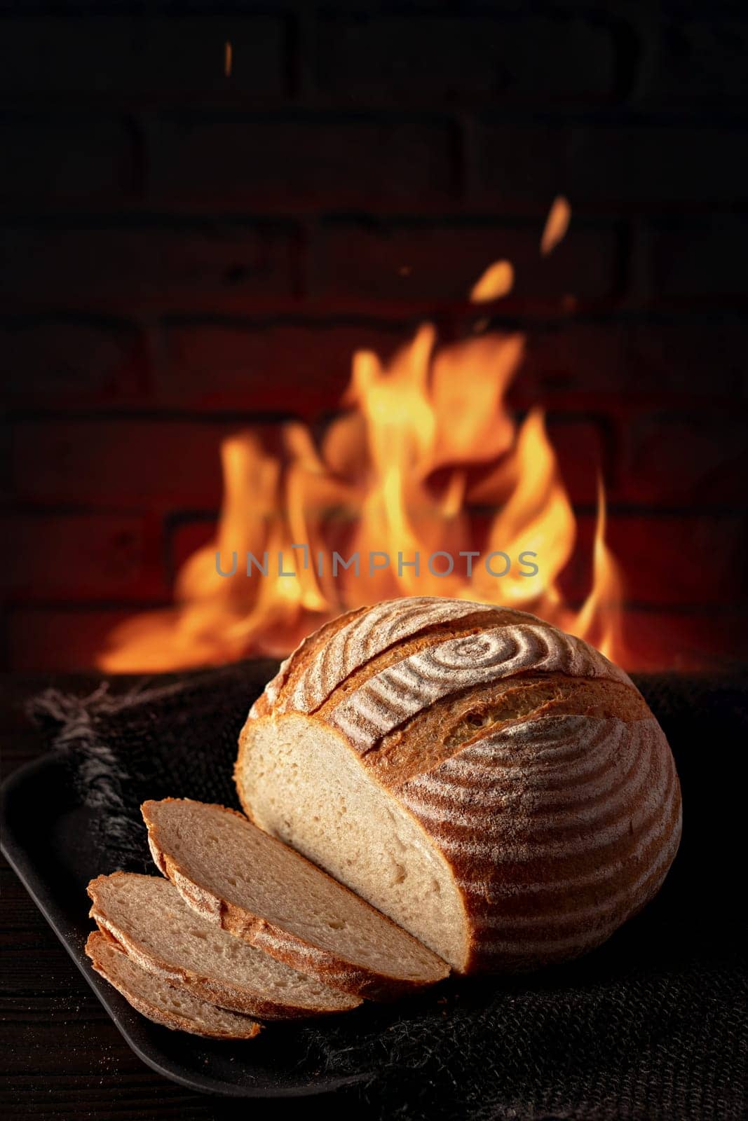 Traditional house bread on the table in front of a brick oven