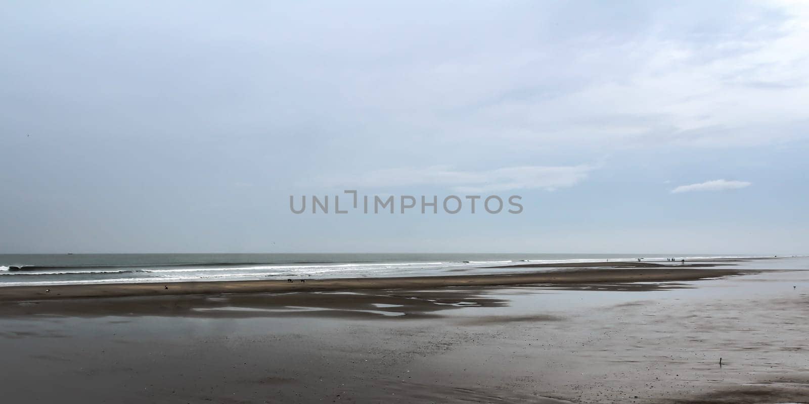 Beautiful tropical beach sunset sky and ocean wave forms a quiet silence atmospheric emotion on a rainy cloudy overcast day. Landscape view. Mood and Tone style image.Travel Nature moody background.