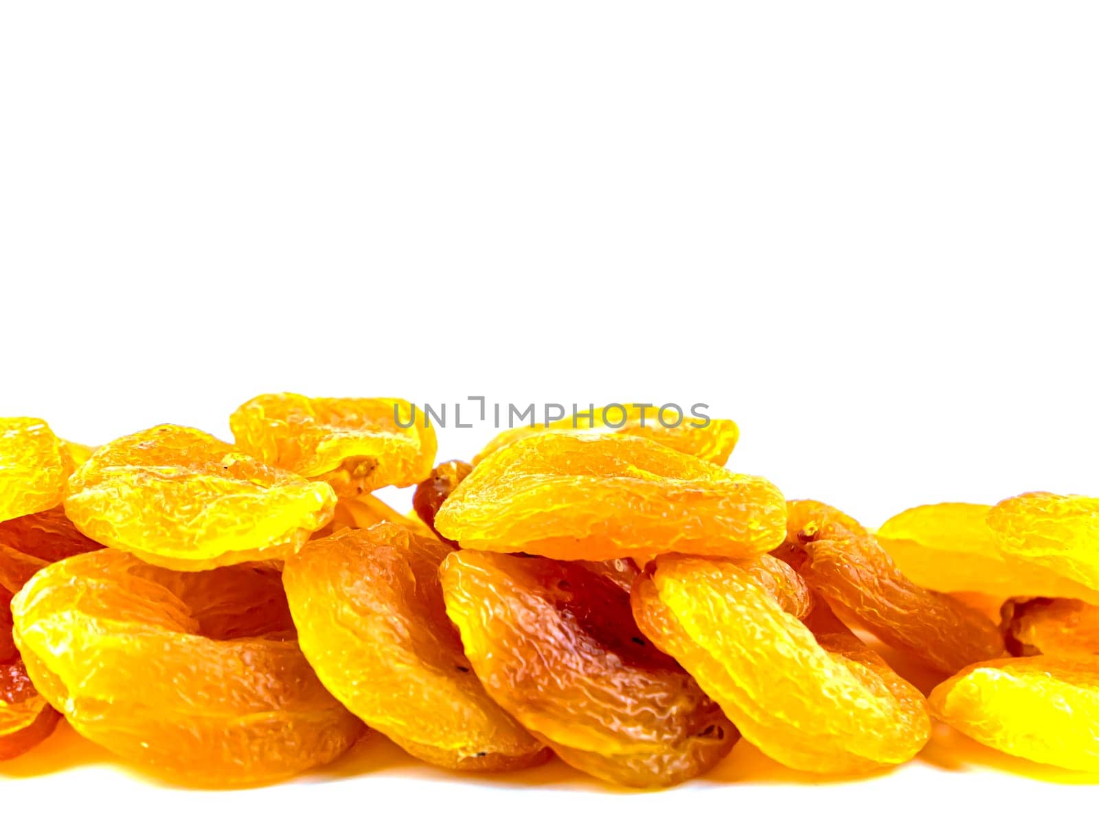 Dried apricots fruits on a white background with place for text. Free place. Background image. Food photo.
