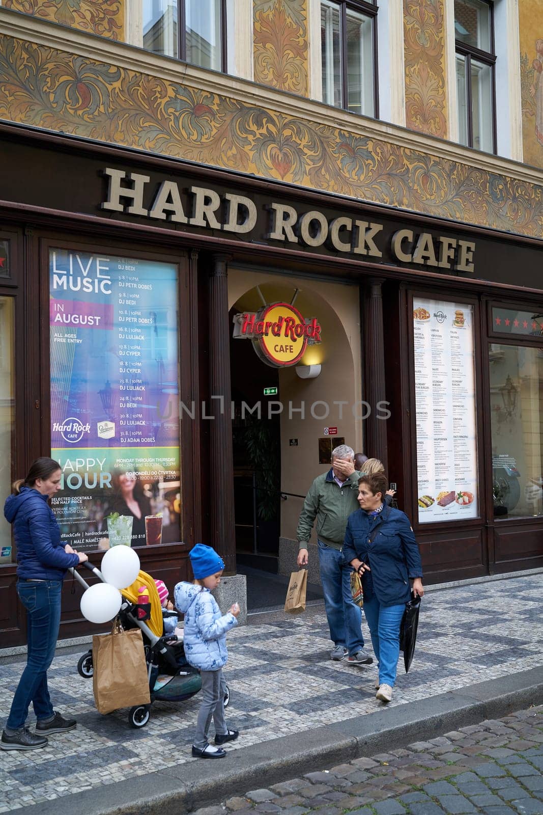 Tourists in front of the popular Hard Rock Cafe in the historic house "U Rotta"" in the Old Town of Prague"