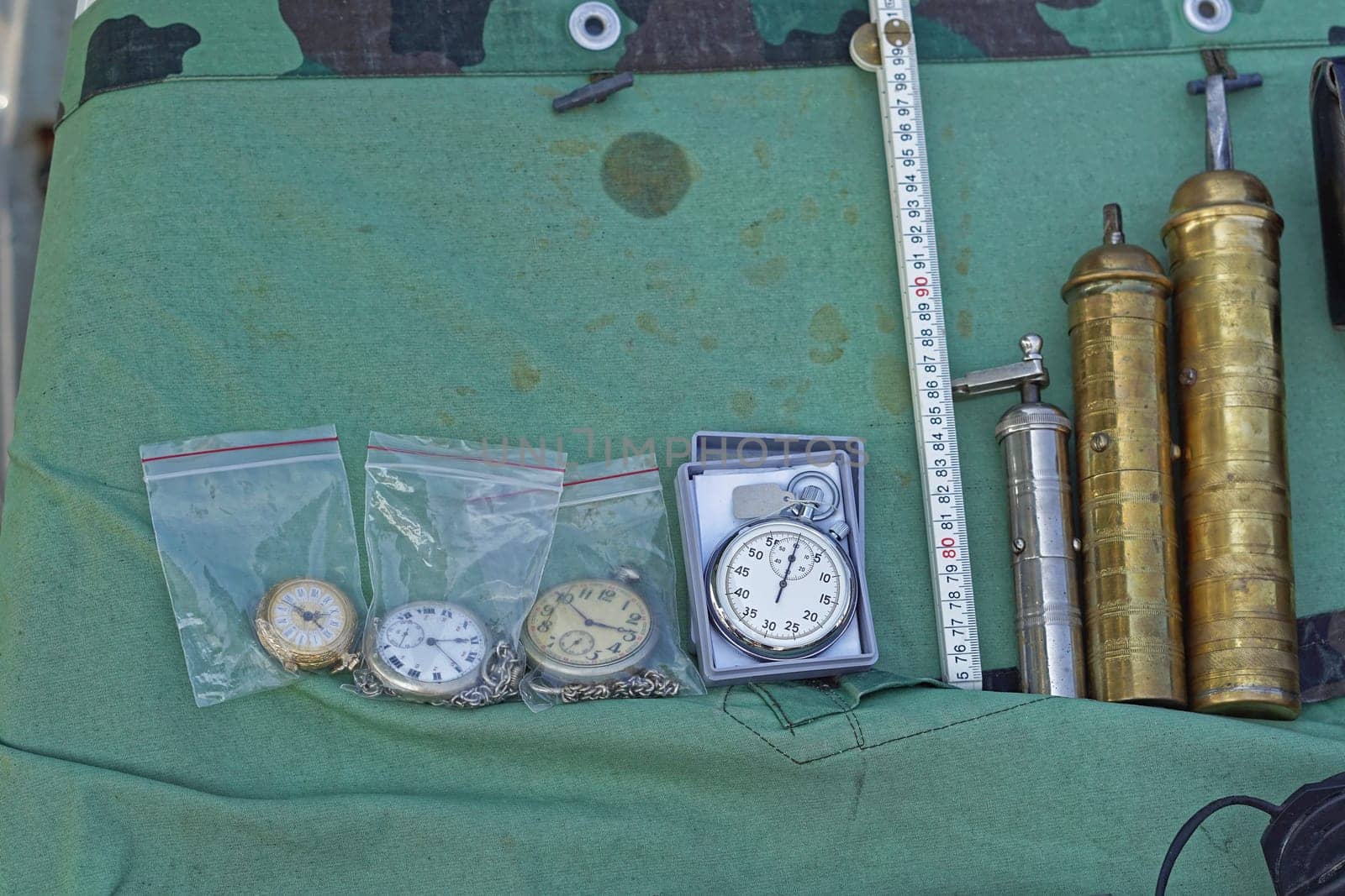 Old clocks and coffee grinders at antique market stall