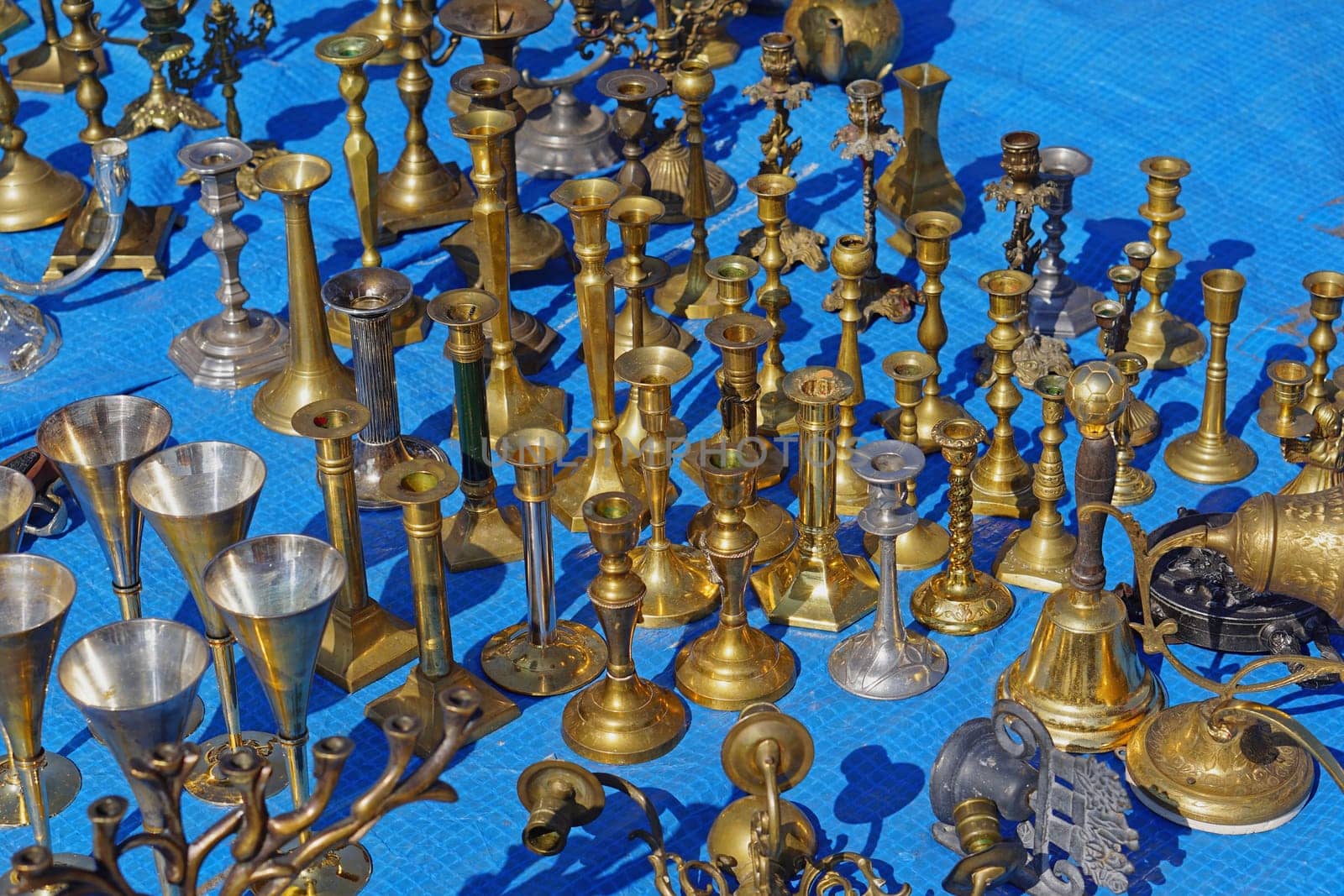 Antique brass and bronze candleholders for sale at flea market