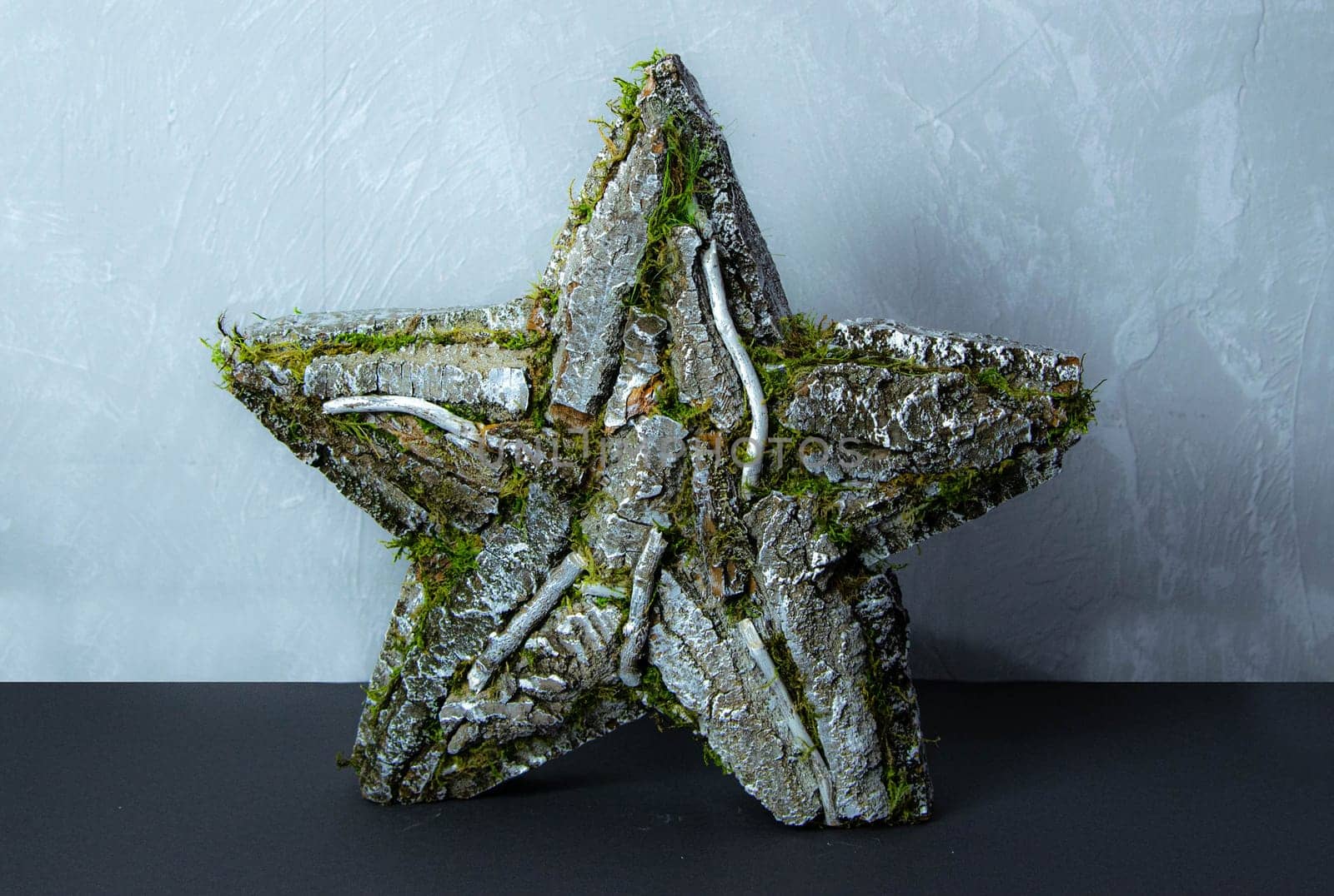 Handmade star decorated with cones and cranberries with christmas deer