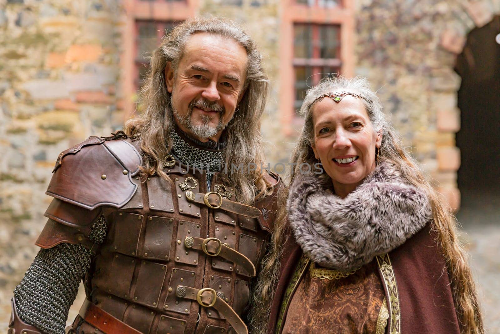 Couple posing robed in beautiful medieval clothing