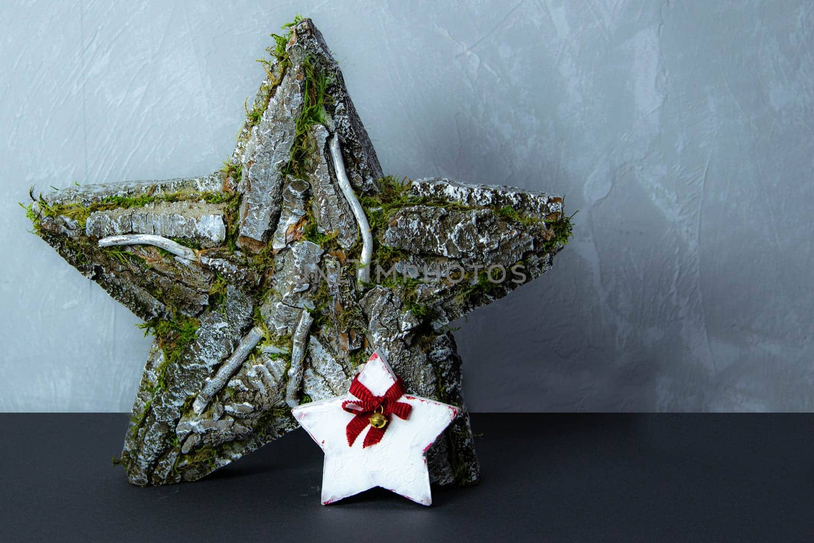 Handmade star decorated with cones and cranberries with christmas deer