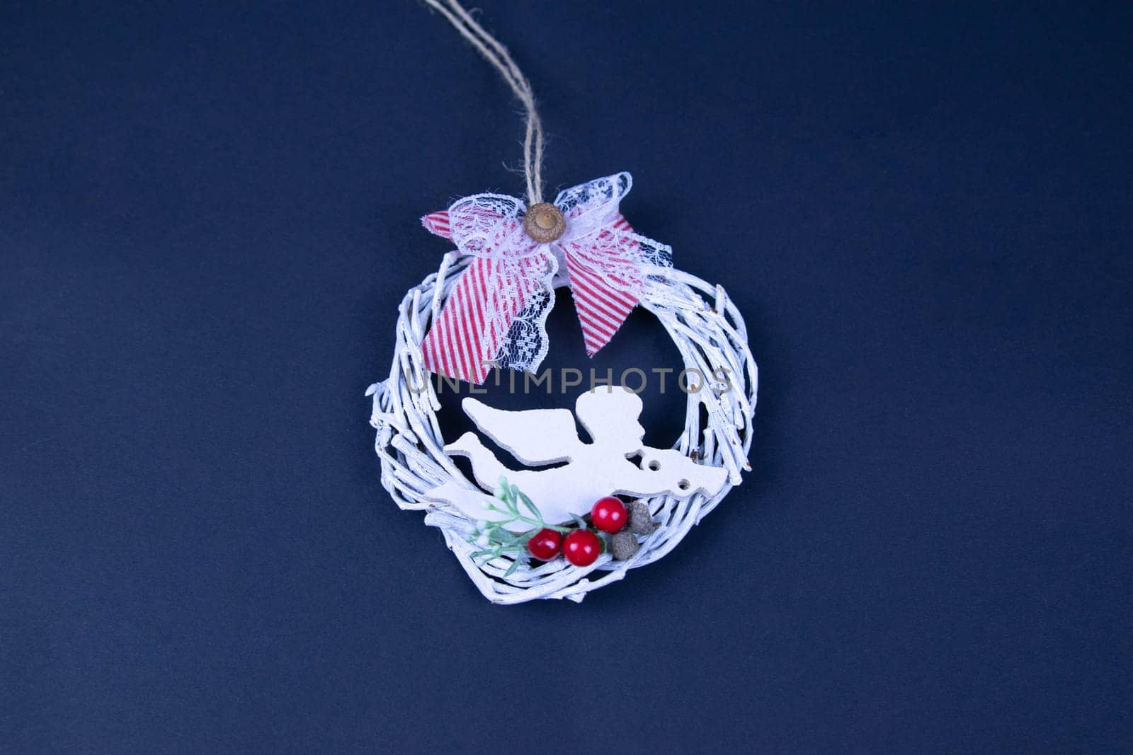 Handmade star decorated with cones and cranberries with christmas deer
