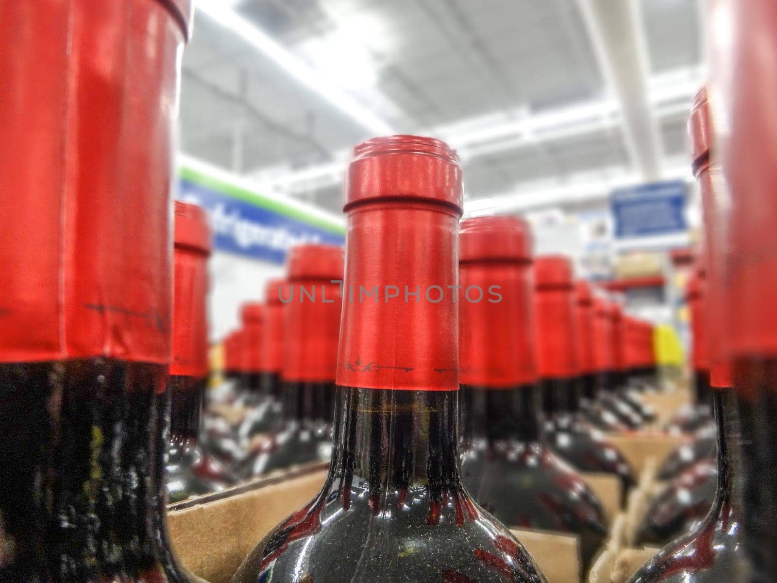 wine bottles stacked on wooden racks shot with limited depth of field