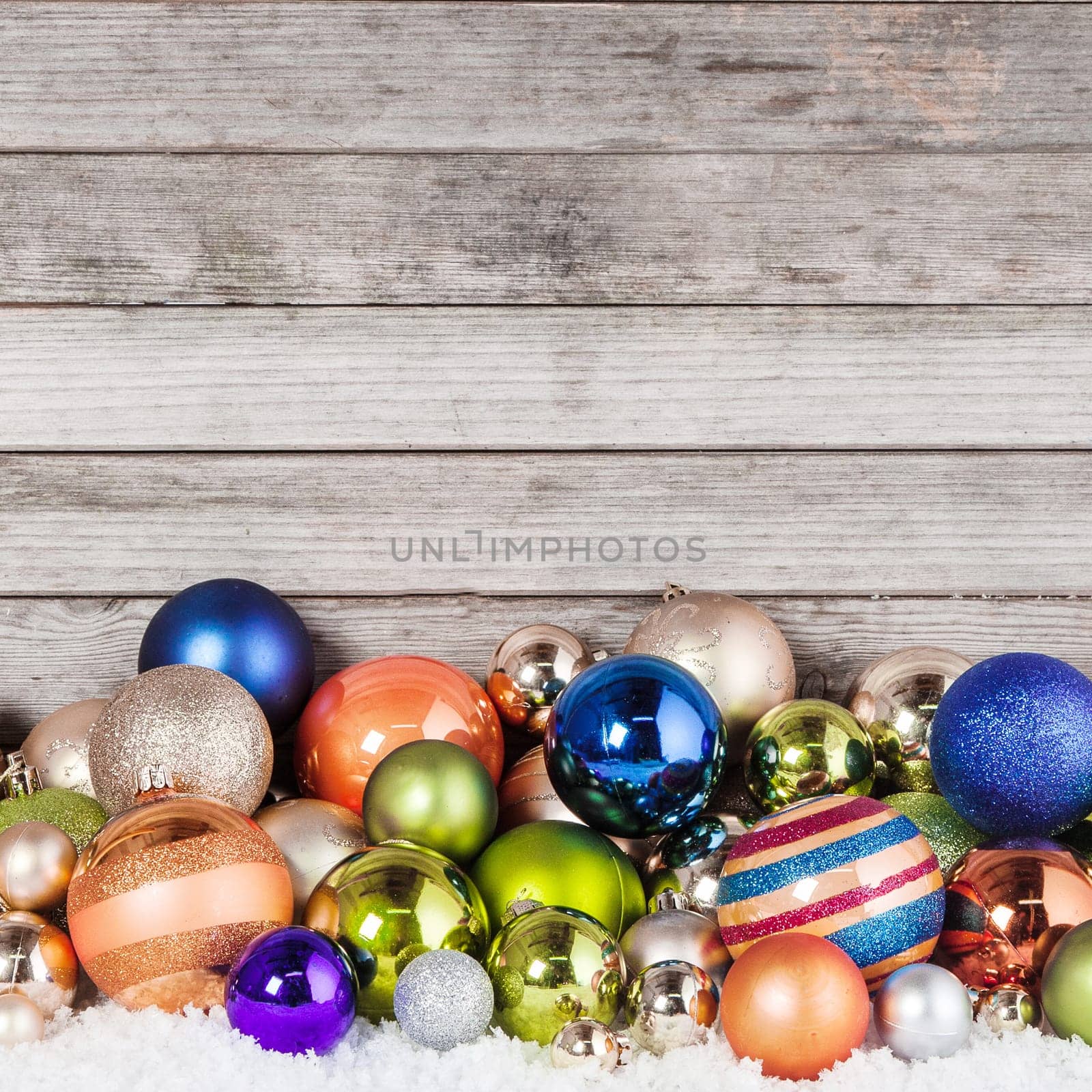 Close up Plenty of Attractive Christmas Balls in Different Sizes on Wooden Wall Background
