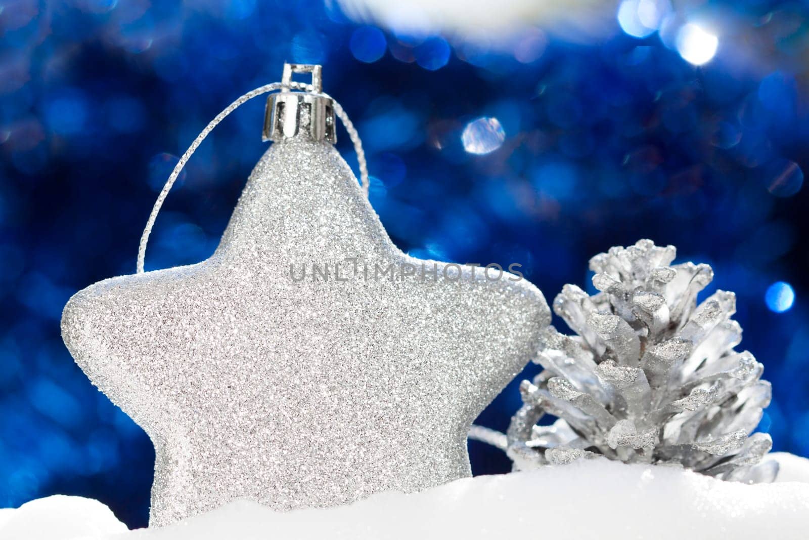Silver christmas decoration with ball and cone on blue background