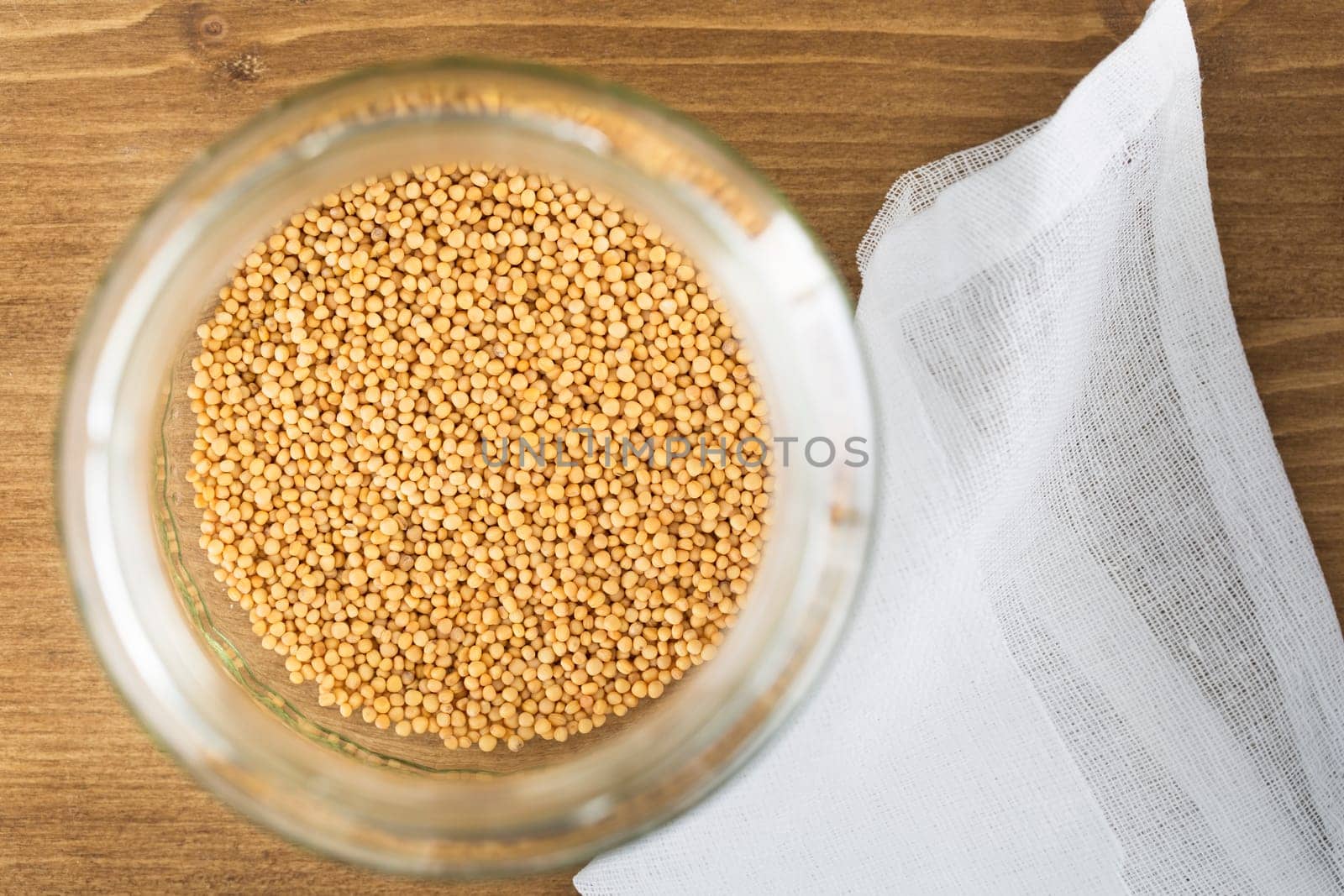 Mustard seeds in sprouting jar viewed from above.