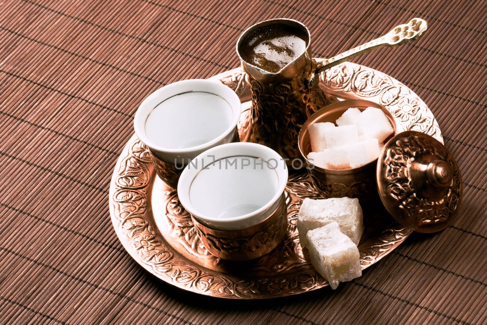 Traditional Turkish coffee set with two cups of coffee on table.