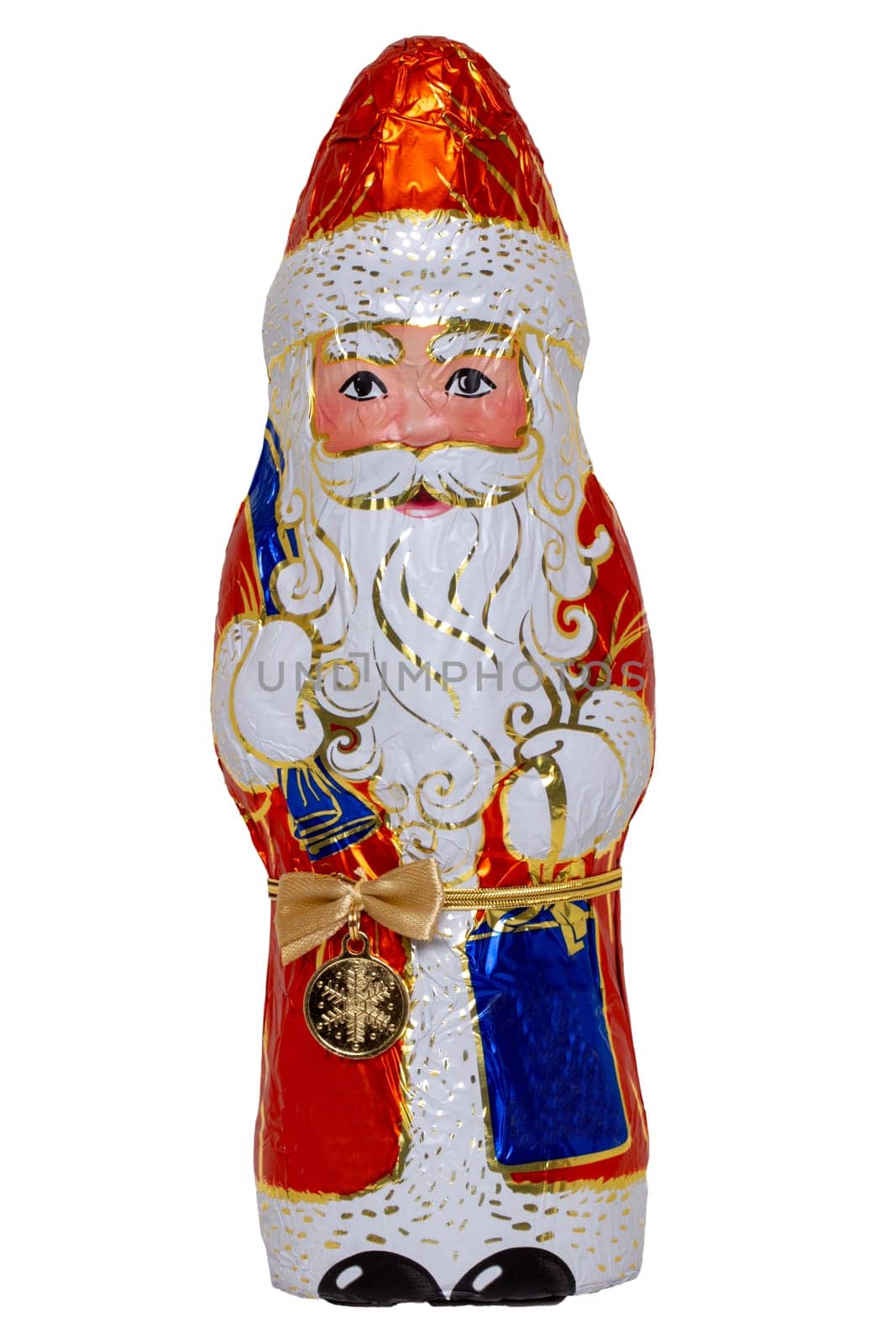 Chocolate Santa isolated. Close-up of a cheerful wrapped chocolate Santa Claus or the good Saint Nicolas figurine isolated on a white background. Macro photograph.