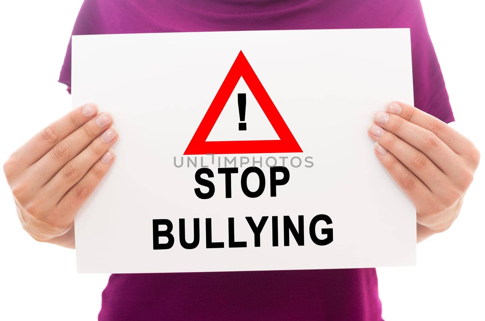 Girl holding white paper sheet with text Stop bullying
