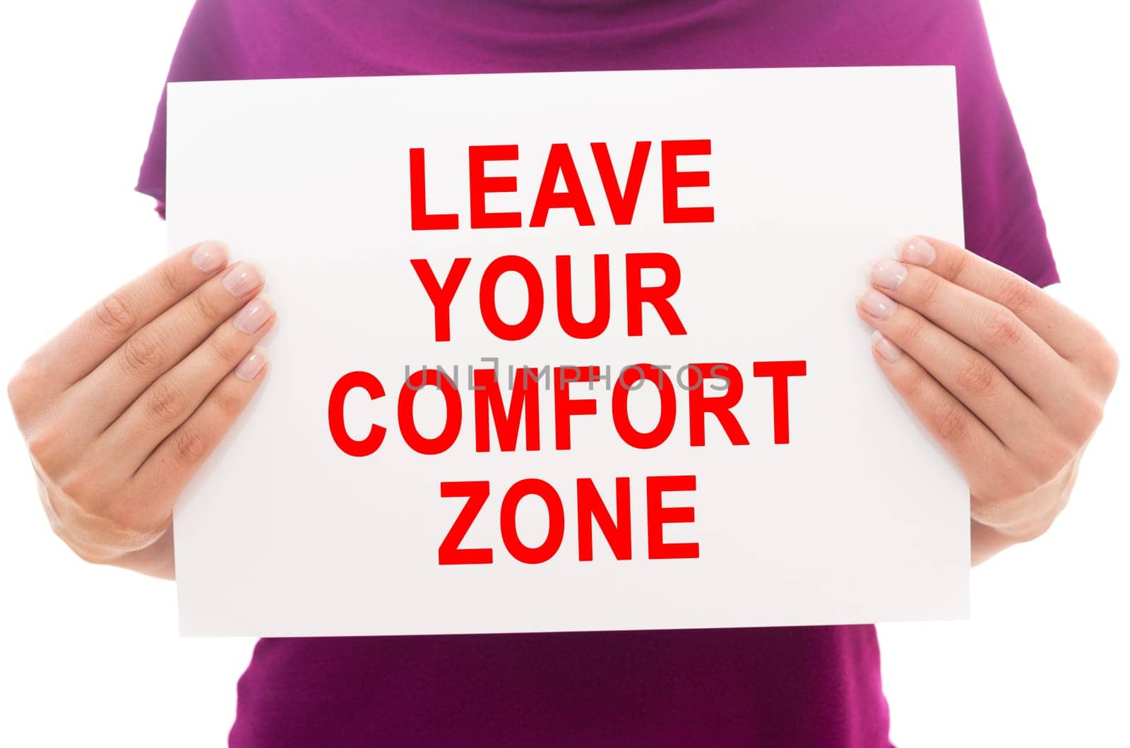 Girl holding white paper sheet with text Leave your comfort zone