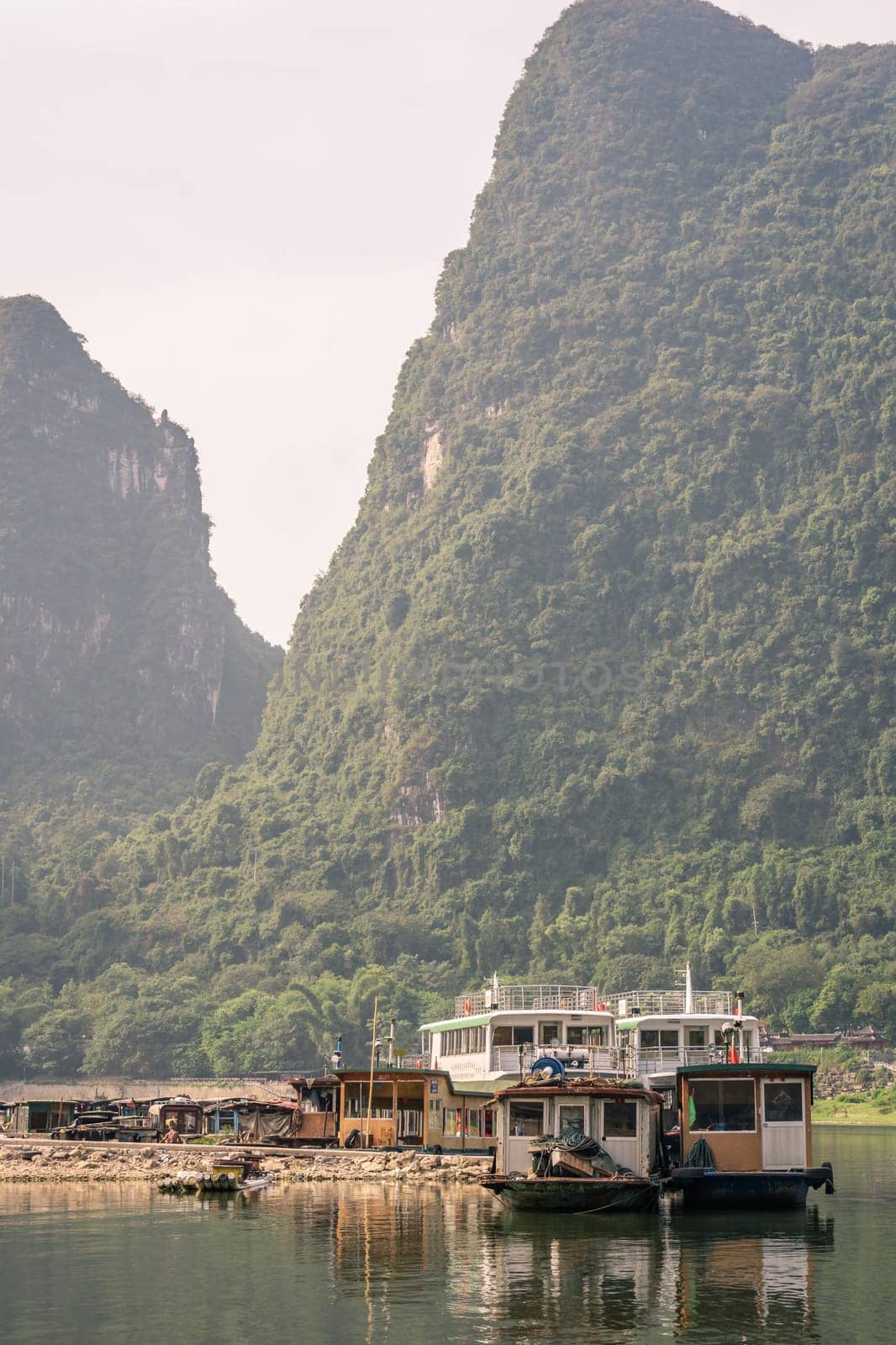 Yangshuo, China - August 2019 : Ferry waiting for passengers on the boat landing and ferry crossing in Yangshuo town, Guangxi Province