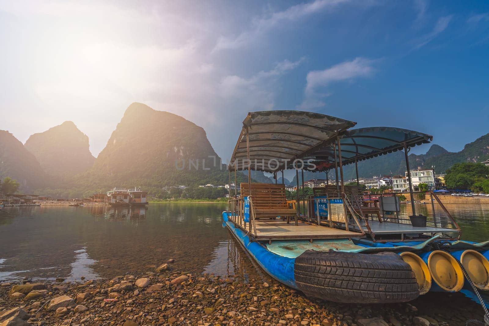 Yangshuo, China - August 2019 : Small tourist and fishermen boats on the Li river shore, the ferry crossing point in Yangshuo