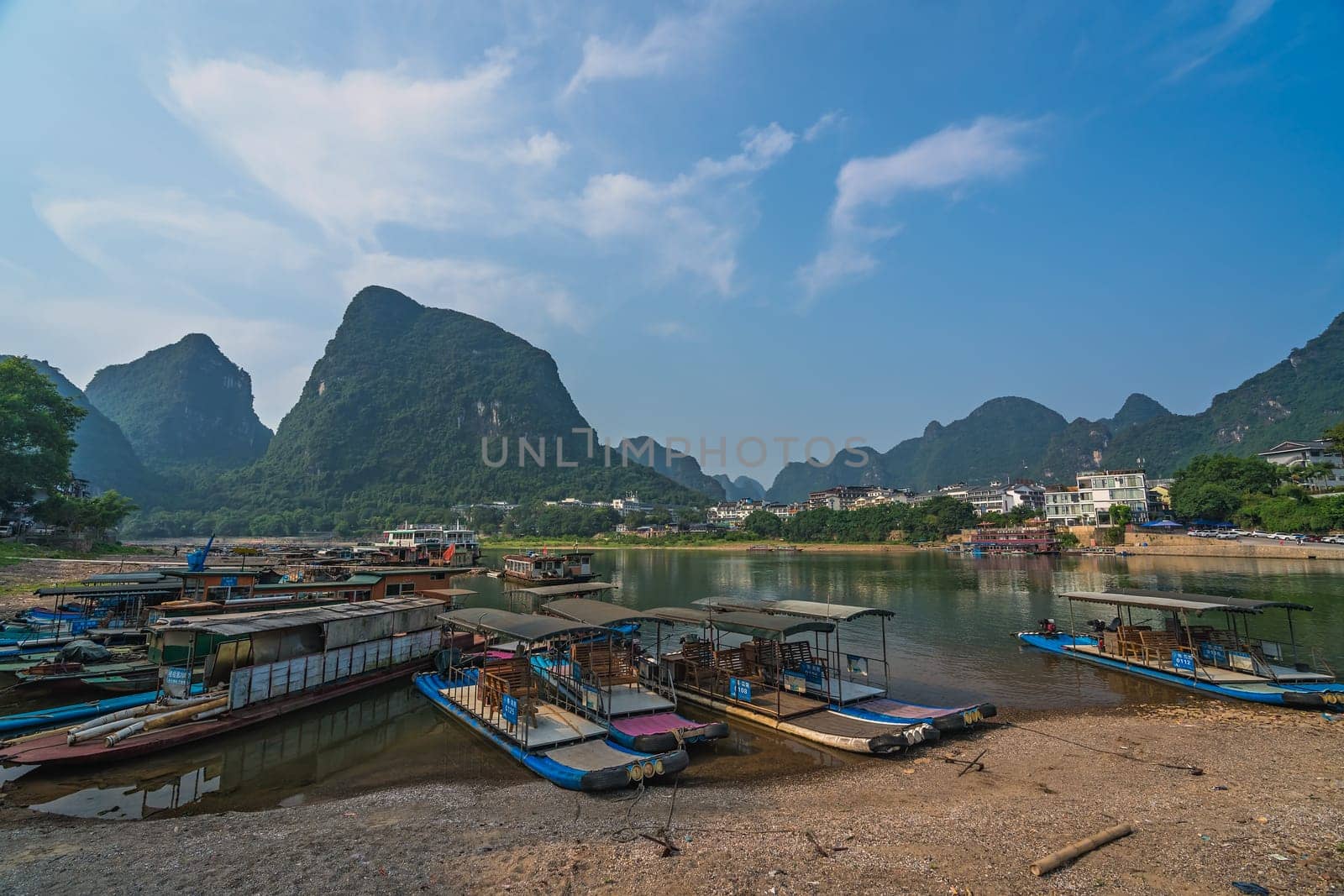 Yangshuo, China - August 2019 : Small tourist and fishermen boats on the Li river shore, the ferry crossing point in Yangshuo