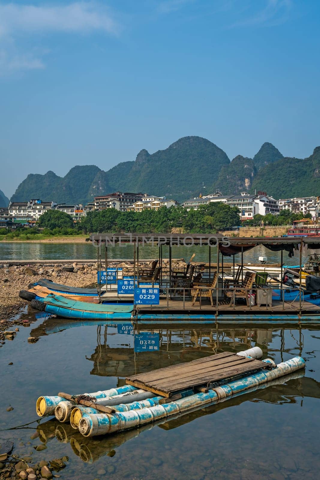 Yangshuo, China - August 2019 : Small tourist and fishermen boats on the Li river shore, the ferry crossing point in Yangshuo