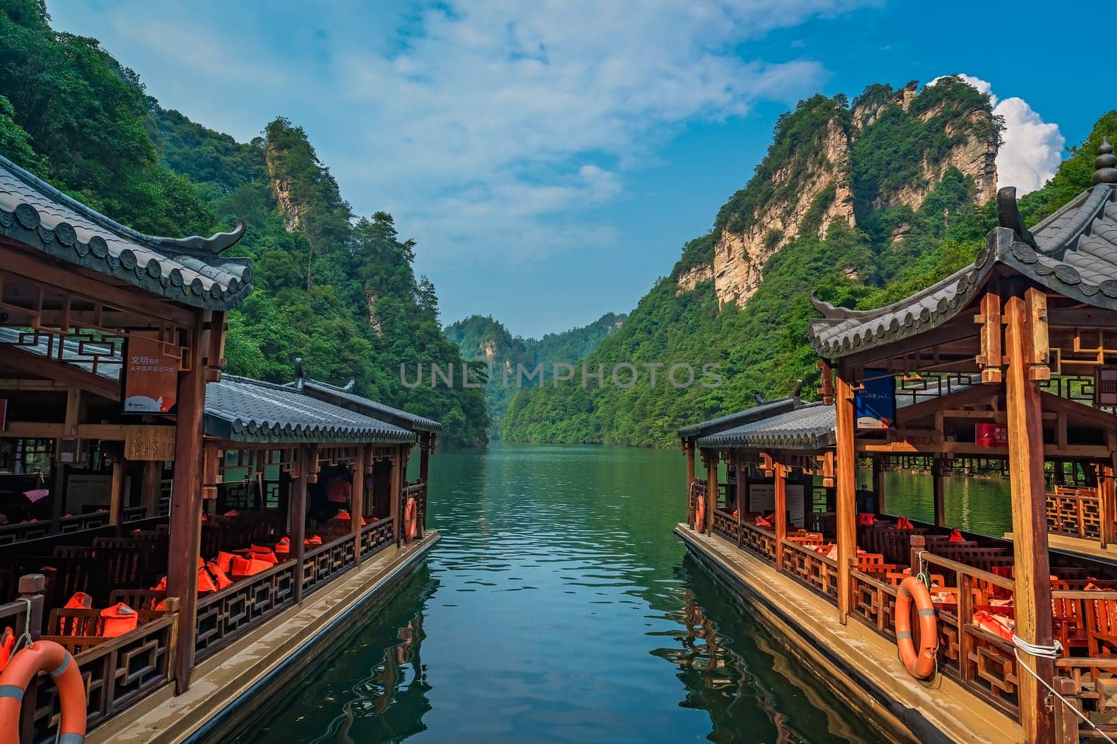 Wulingyuan, China -  August 2019 : Tourist boats waiting for passengers on the lakeshore of Baofeng Lake, Zhangjiajie National Forest Park, Hunan Province, China, Asia
