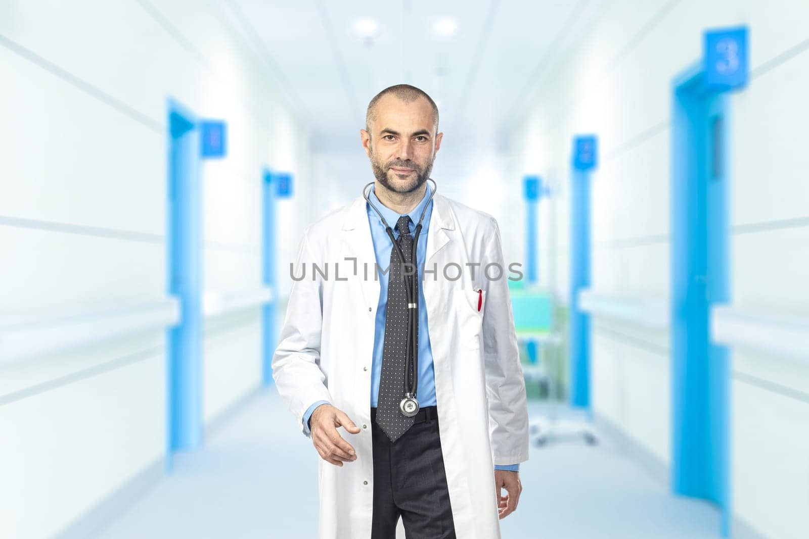 portrait of a man walking aisles of a hospital. safe and professional expression.