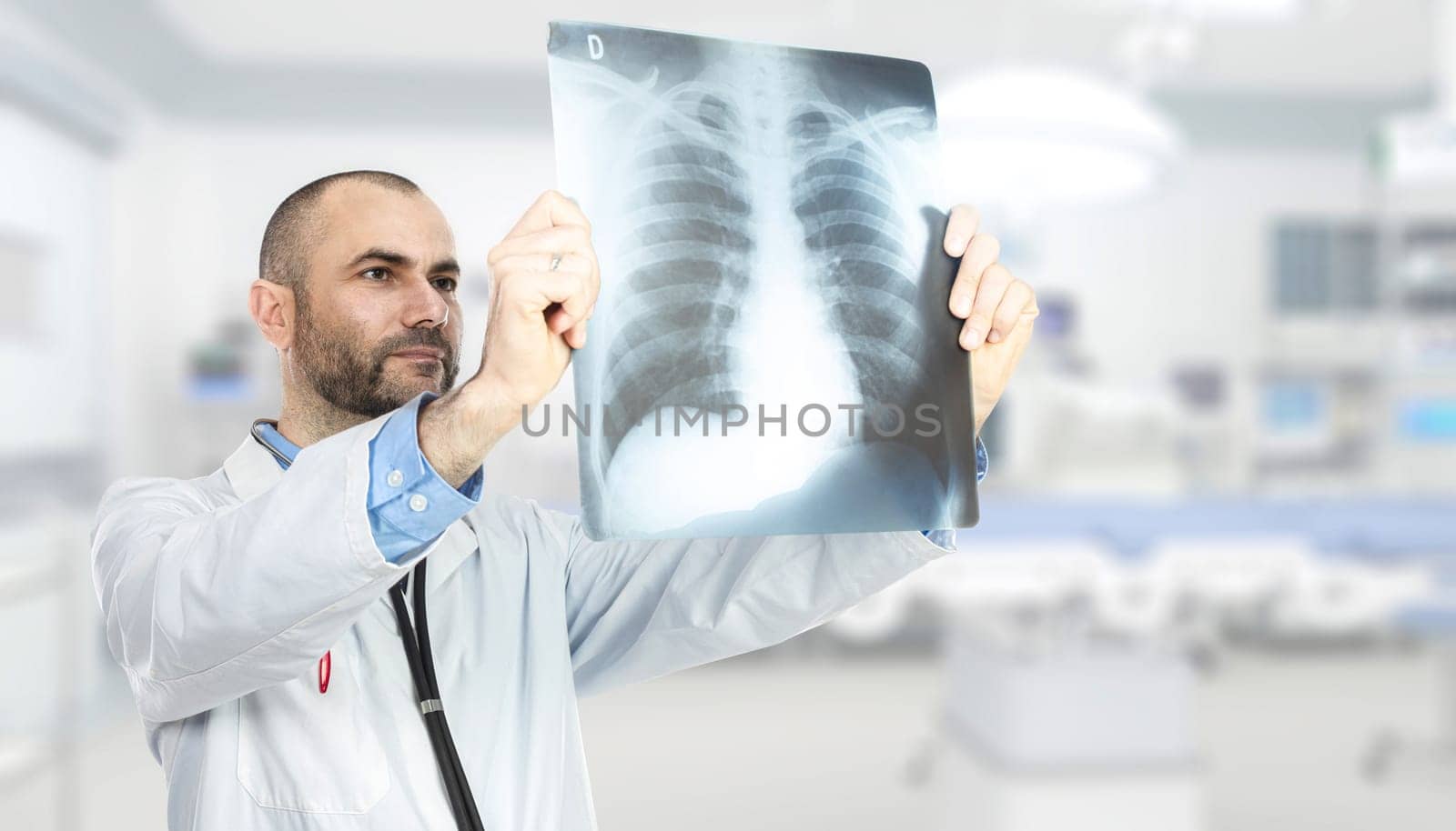 portrait of a caucasian doctor checking an x-ray inside the hospital. Concept of health care and specialized medicine.