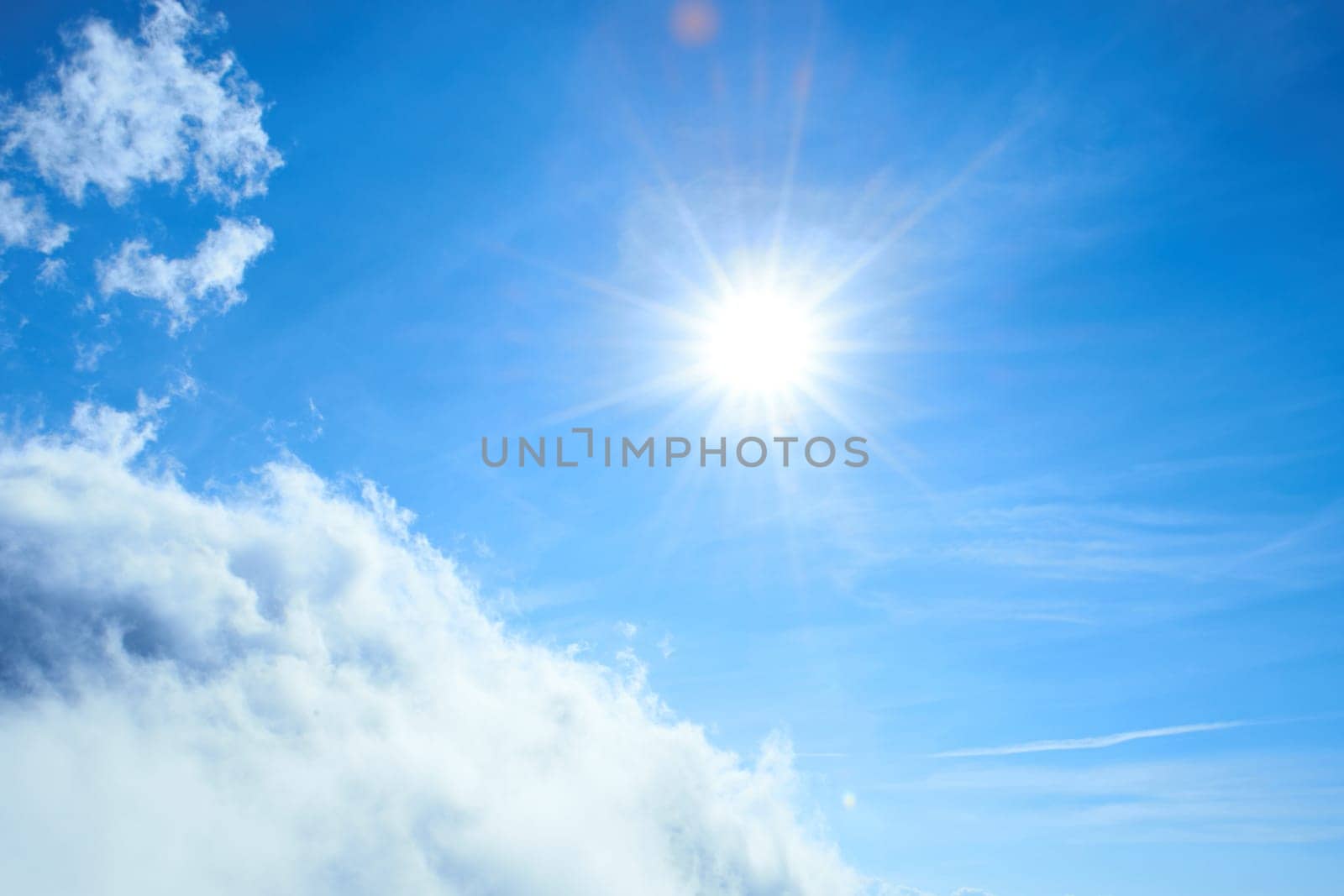 Beautiful blue sky with sun and clouds