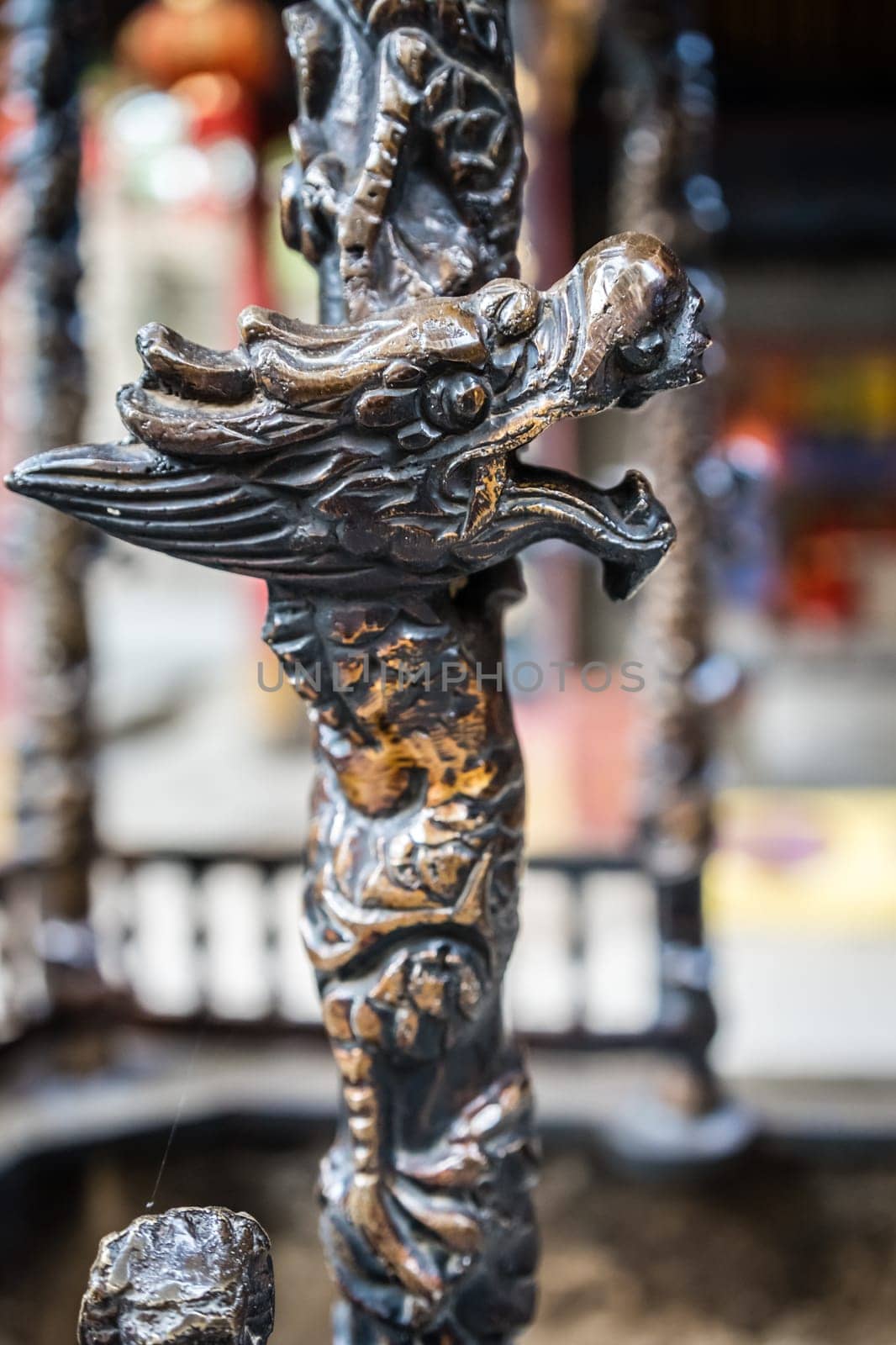 Close up of a dragon head sculpture decoration on a wooden stick, Buddhist Temple wall in Huashan town, Shaanxi Province, China