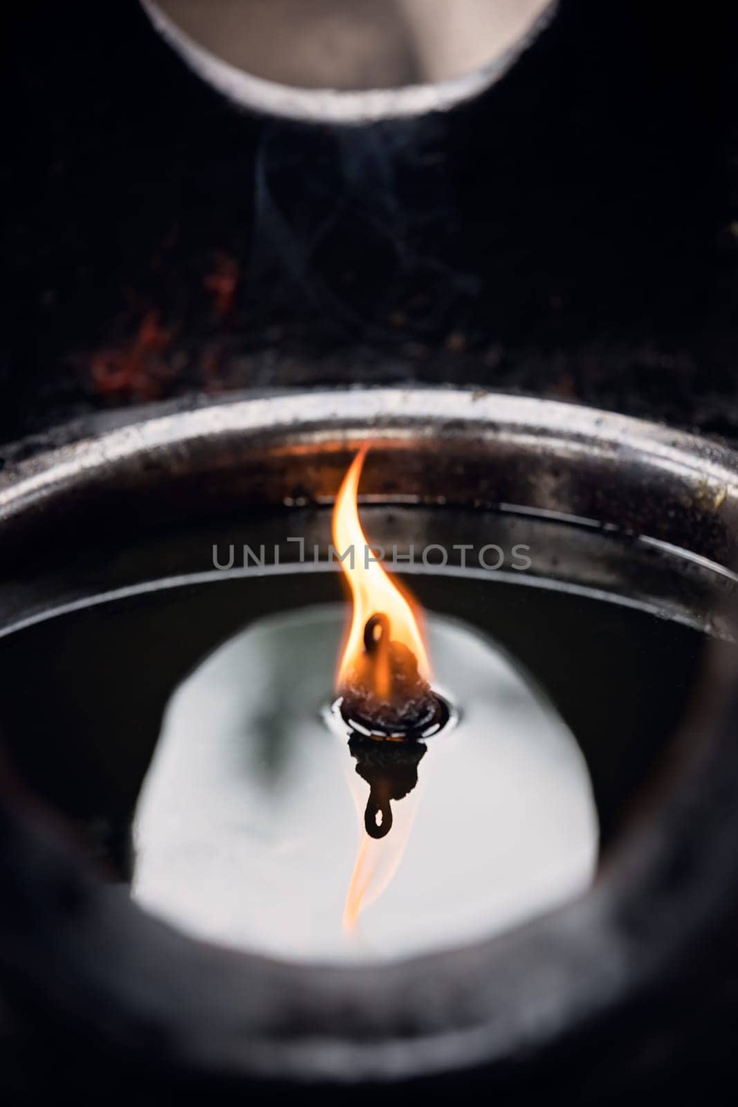 Fire burning in the memorial candle in the Wenshu Monastery, Chengdu, China