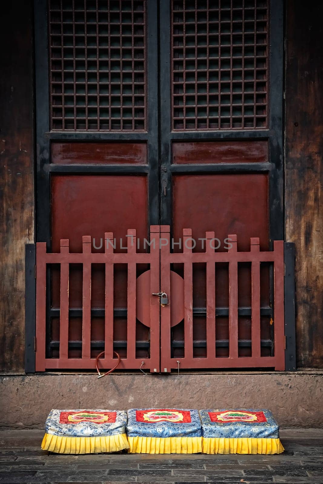 Three colorful praying kneeling pads in the courtyard of the Buddhist Wenshu Monastery, Chengdu, Sichuan Province, China