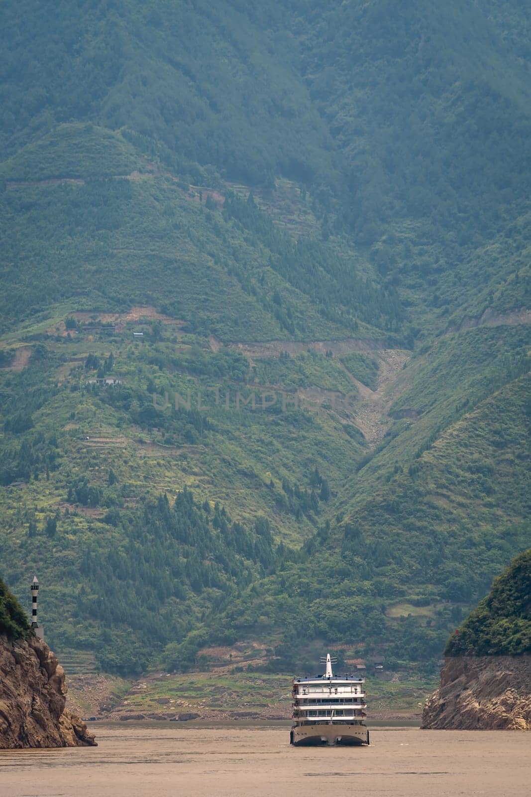 Luxury passenger cruise ship sailing through the gorge on the magnificent Yangtze River, China