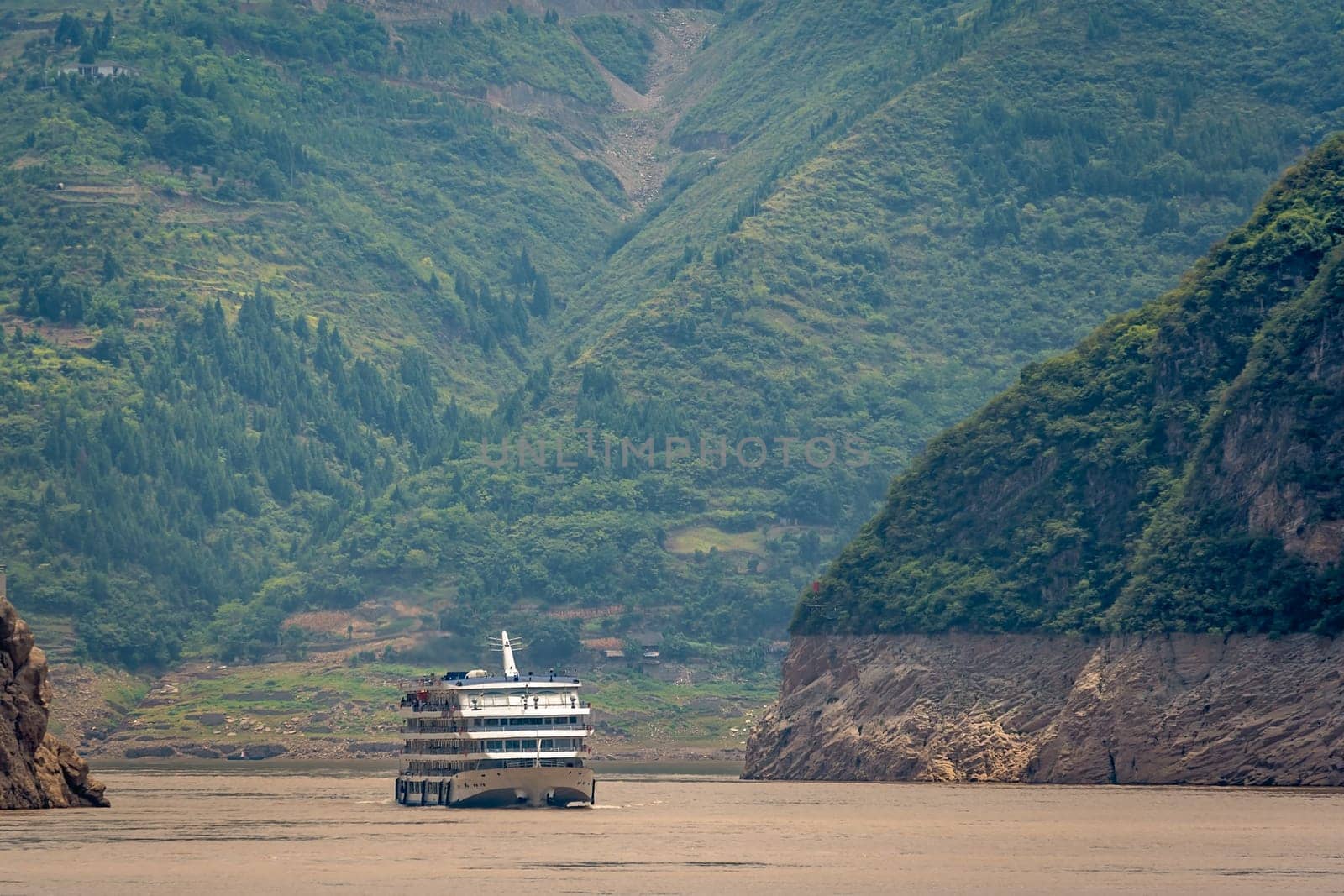 Luxury passenger cruise ship sailing through the gorge on the magnificent Yangtze River, China