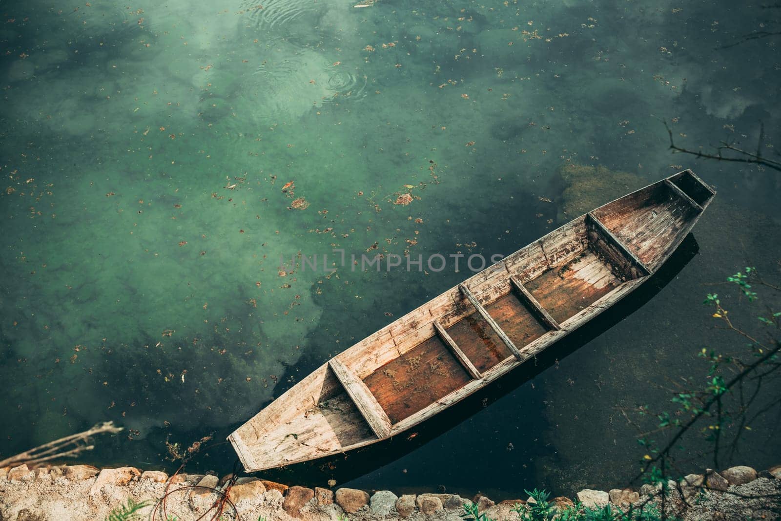 Small old wooden boat on the riverbank in Wellingyuan, China