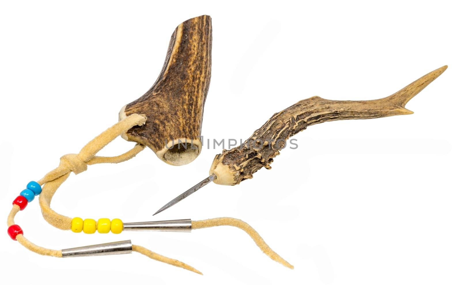 Sewing awl of the North American Indians made of stag horn with metal tip and decorated with leather cords and glass beads