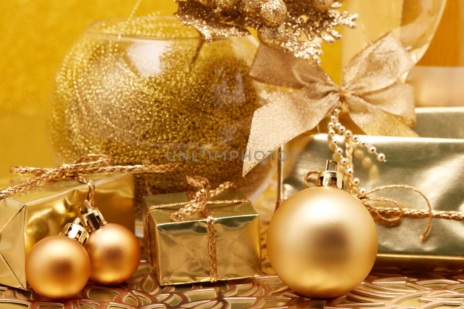 Golden Christmas ornaments and  gift boxes on gold background. Christmas. New Year. Design element for greeting card, invitation, advertising