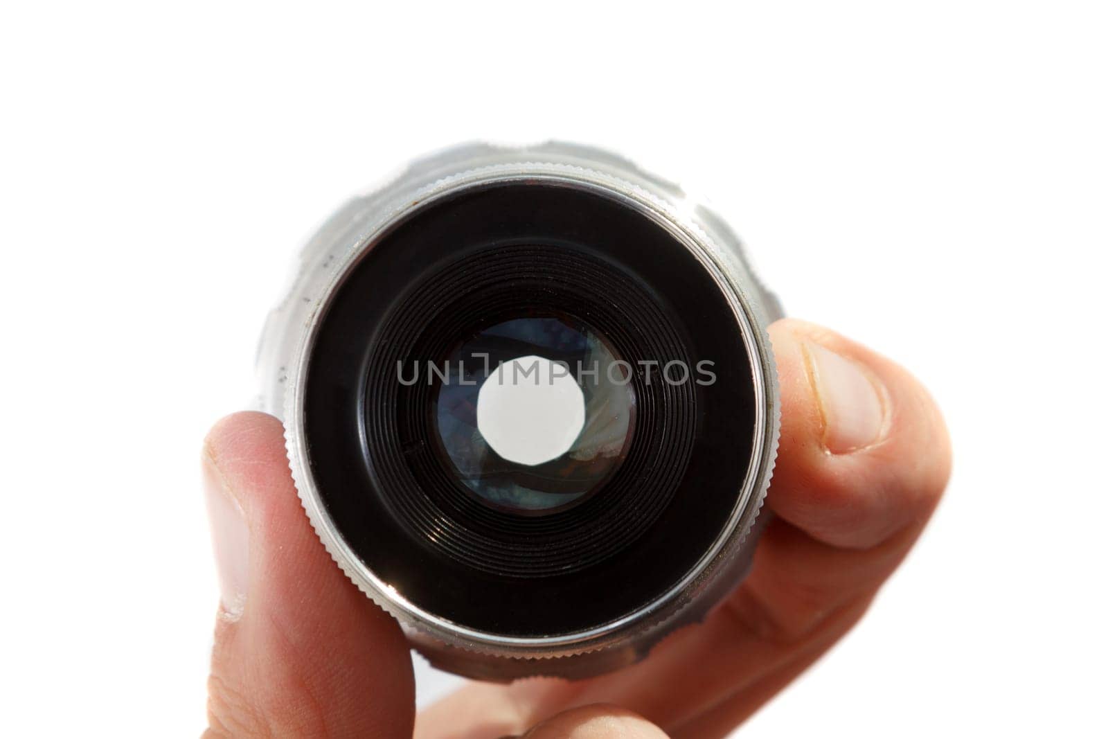 Hand holding retro camera lens on white background