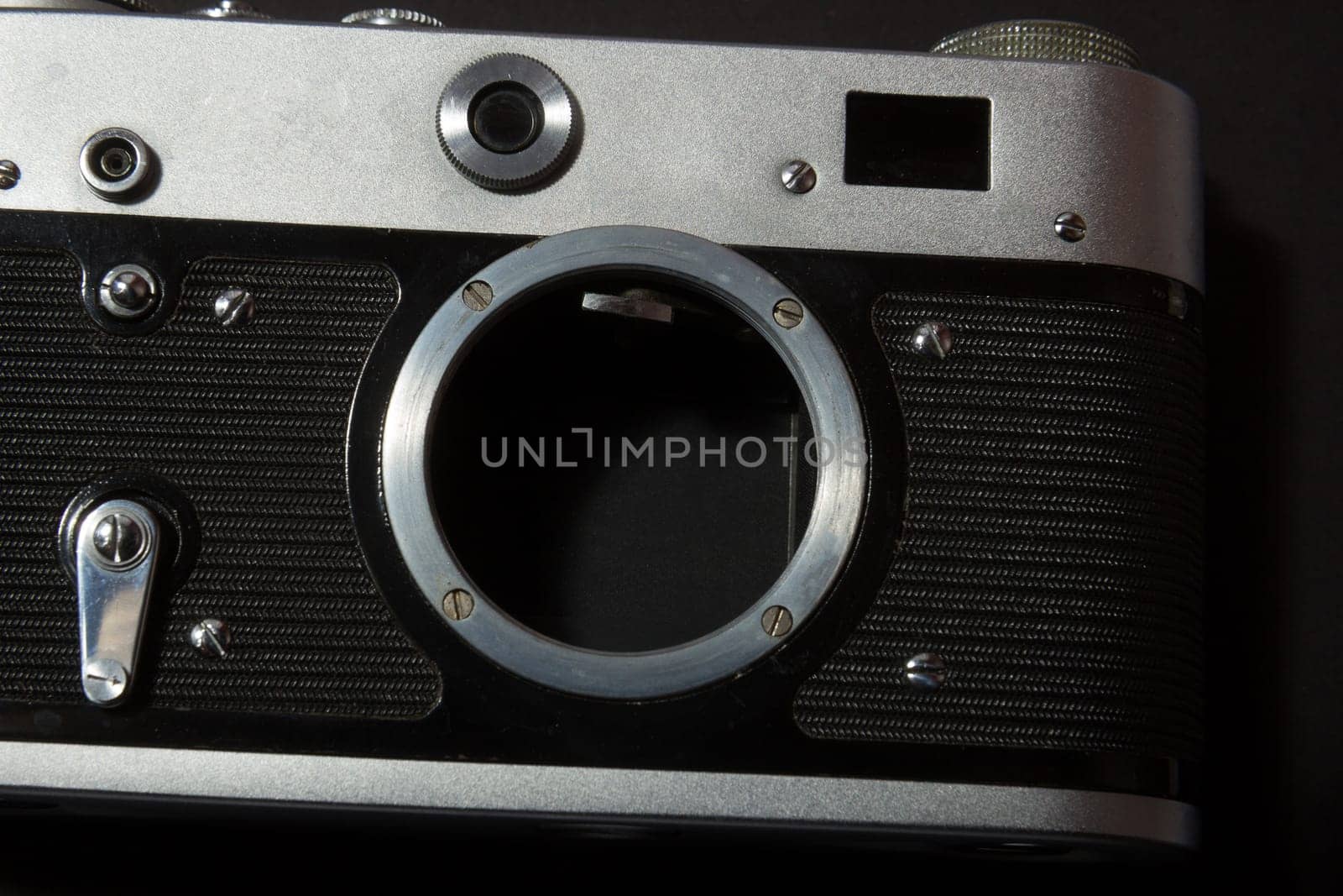 Retro film photo camera on black background