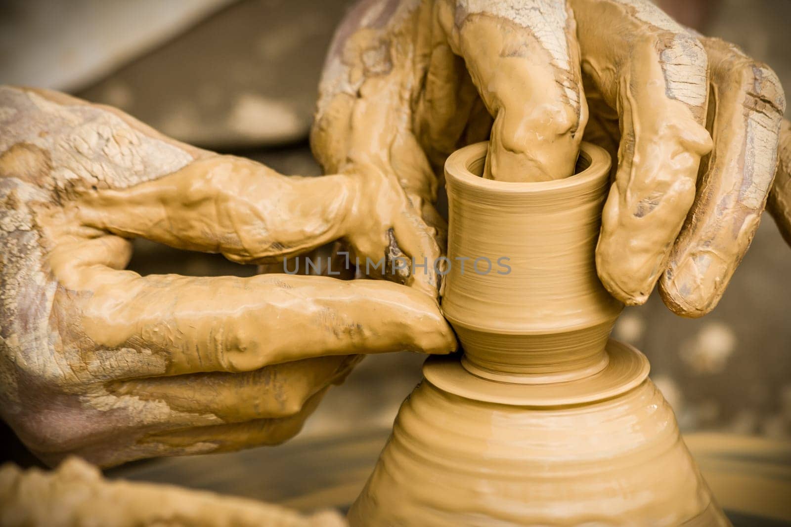Potter modeling on a potter`s wheel