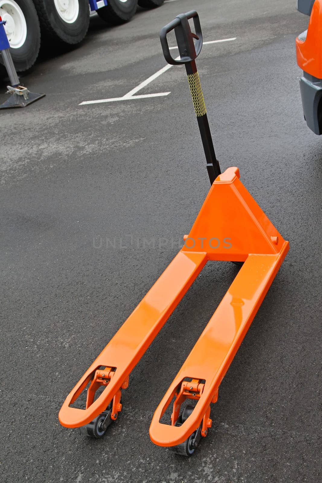 Orange manual pallet jack  truck for transport